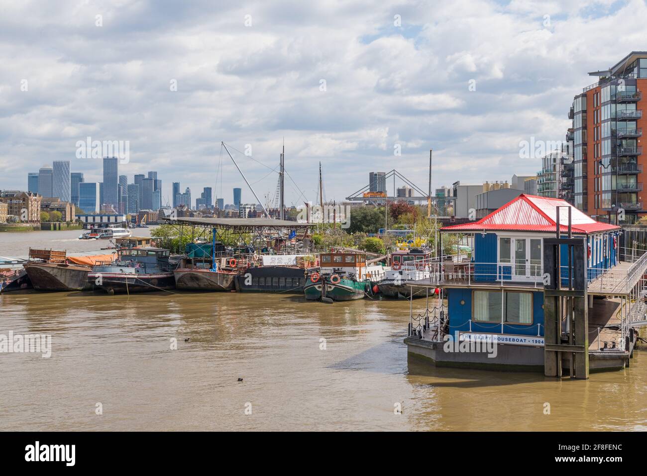 Houseboats moored on the River Thames at New Concordia Wharf, near