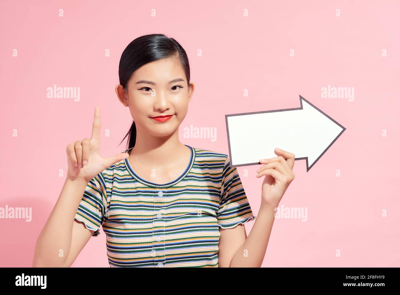 Beautiful woman holding a blue arrow pointing to her right side Stock ...