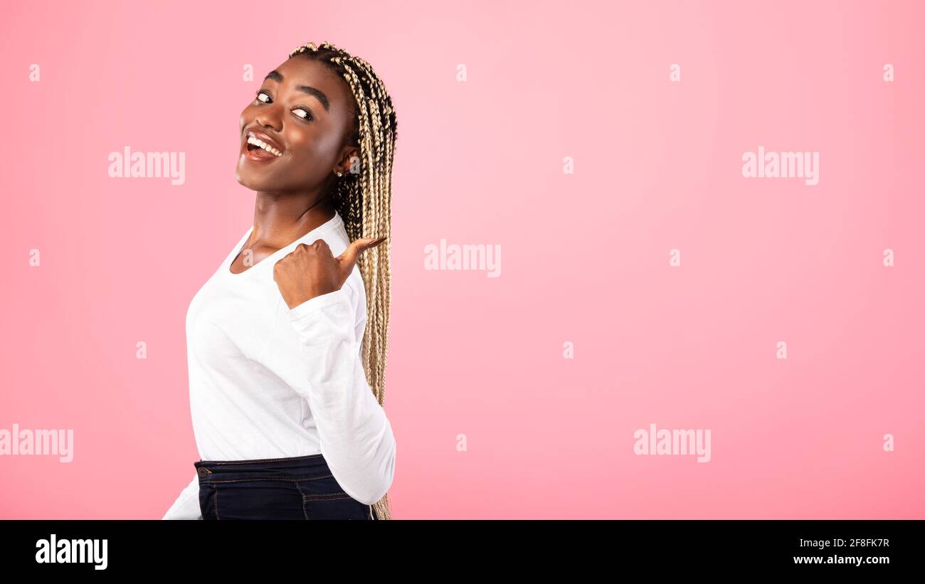 Excited black woman pointing back at copy space Stock Photo