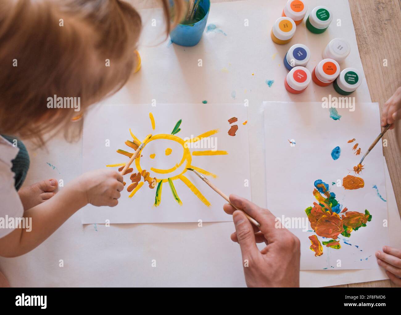 small children draw drawings on the floor with watercolors close-up ...