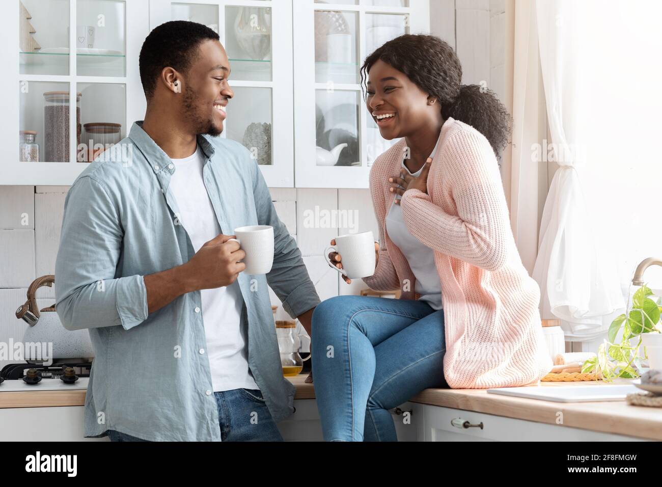 Joyful Black Lovers Having Fun Together While Drinking Coffee In Kitchen Stock Photo