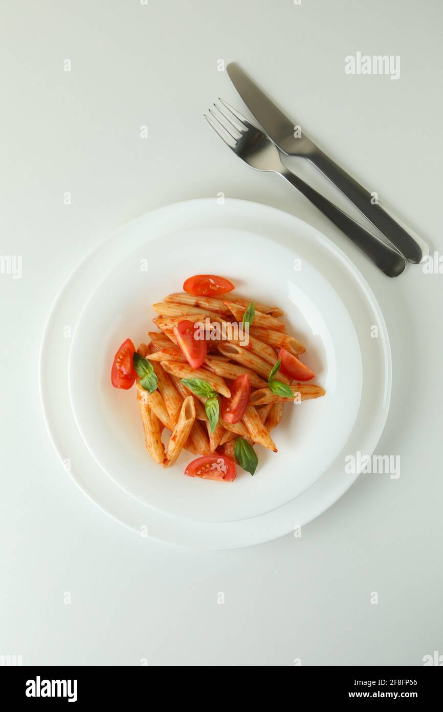 Plate with pasta with tomato sauce on white background Stock Photo - Alamy