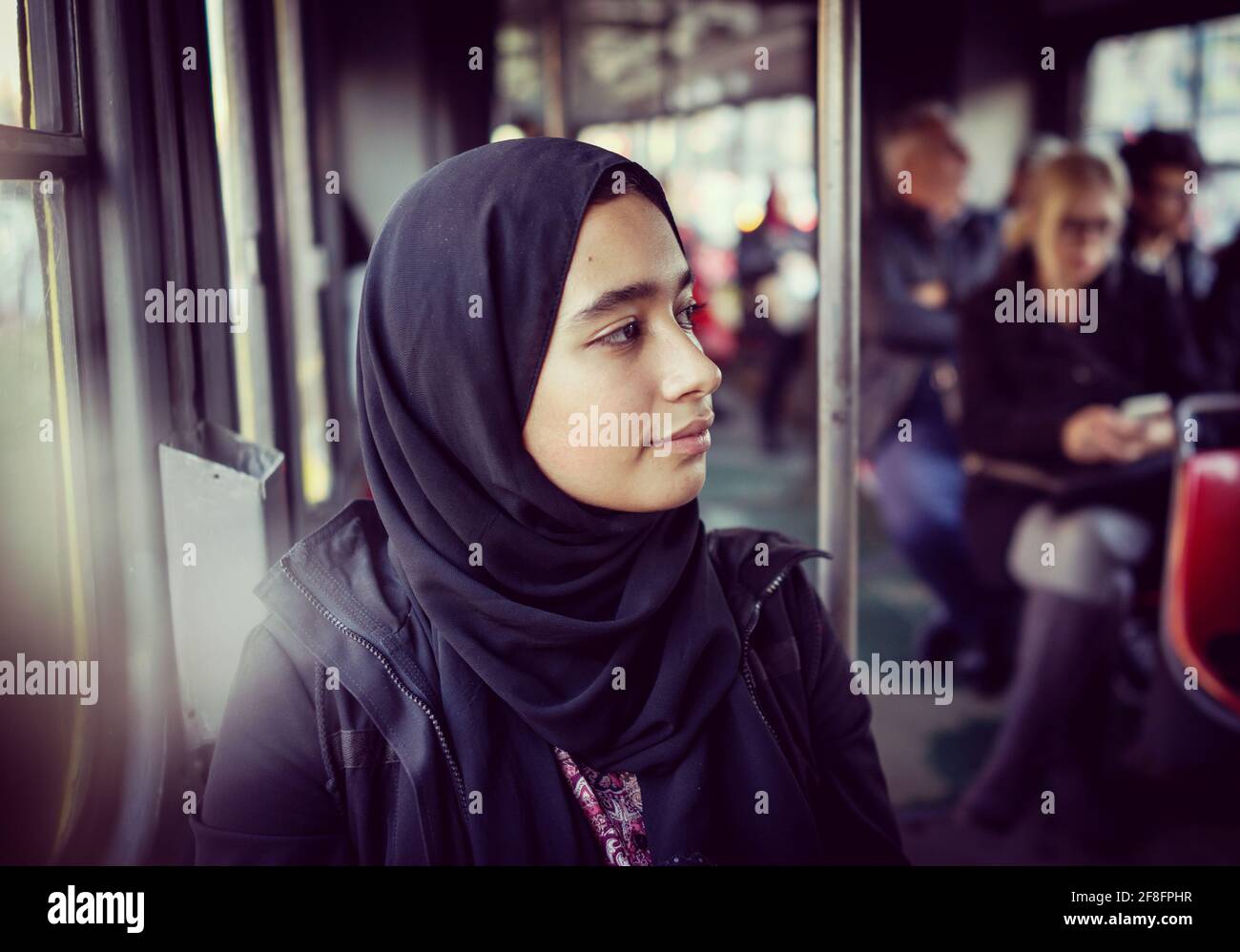 Middle Eastern girl riding public transport in the city Stock Photo