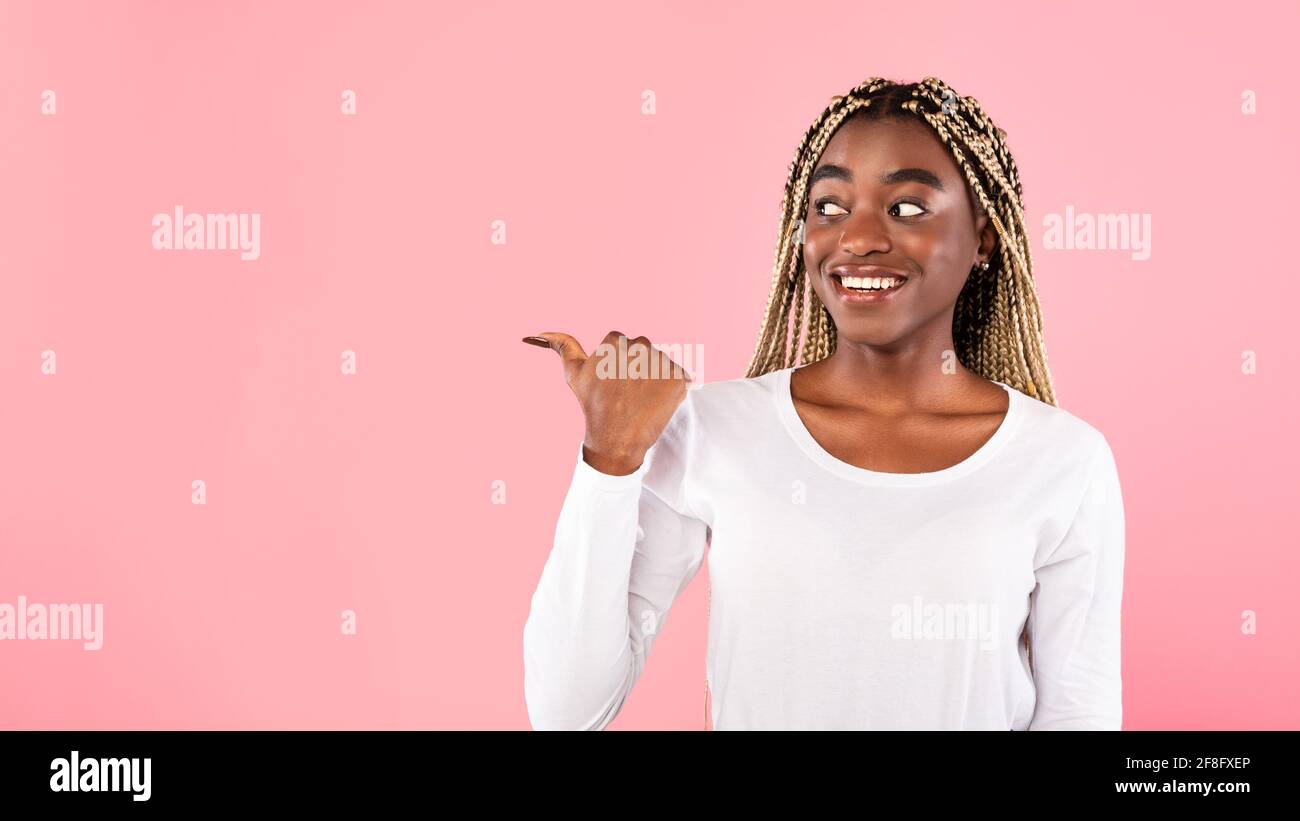 Excited black woman pointing away at copy space Stock Photo