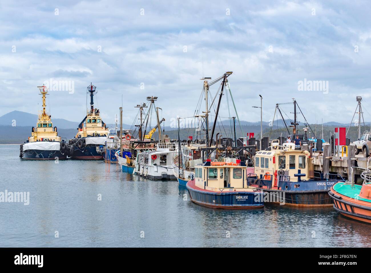 Large pusher tugs Wistari (Left) and Cooma moored with other commercial and fishing vessels at the Port of Eden on the NSW south coast of Australia Stock Photo