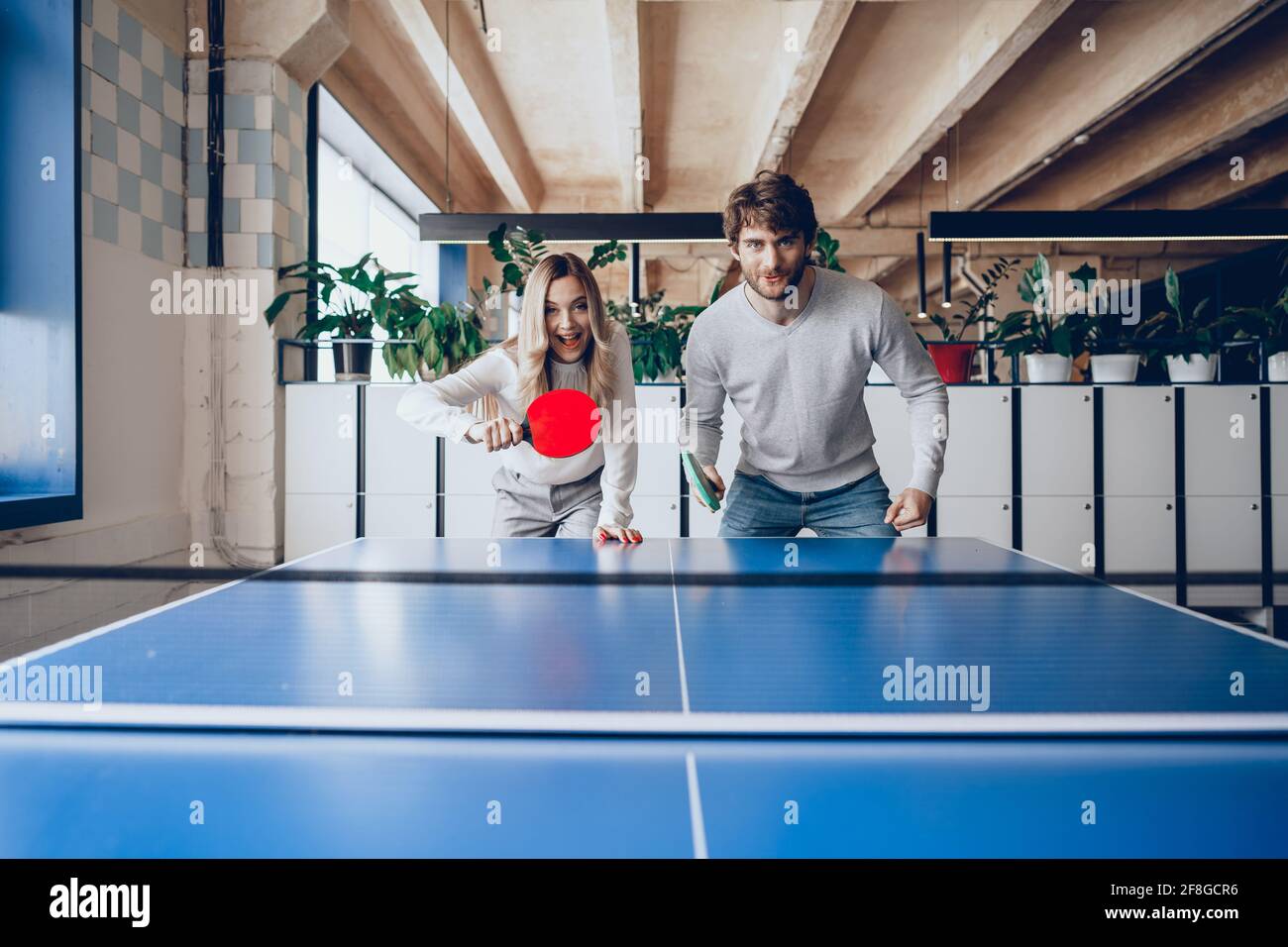 Young people, man and woman playing table tennis Stock Photo Alamy