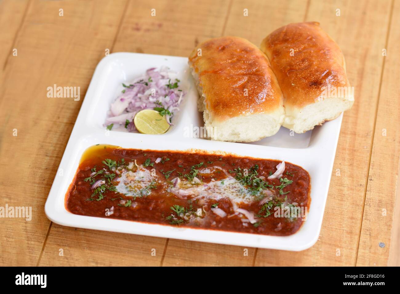Indian delicious Pav Bhaji with onion and coriander spread on top of
