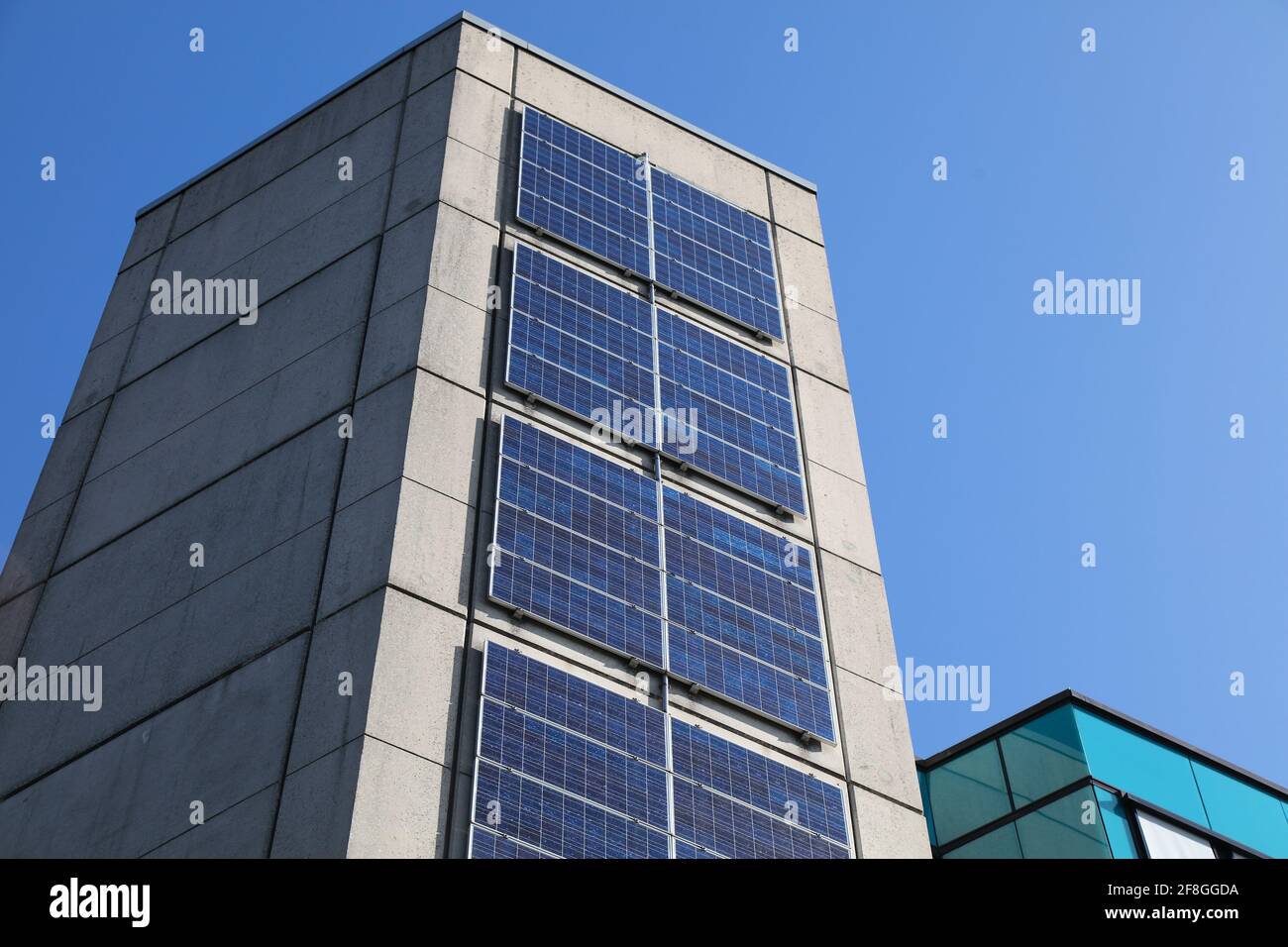 Solar panels on vertical surface of a public building in Marl, Germany. Photovoltaic energy generation in Germany. Stock Photo
