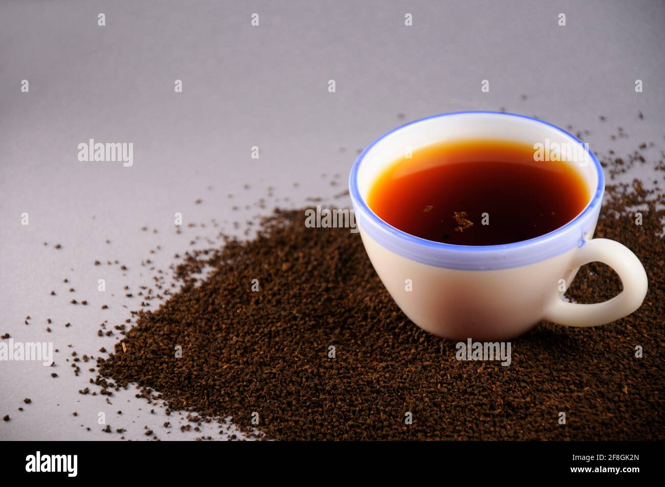 Cup of tea with and black tea leaves Stock Photo Alamy