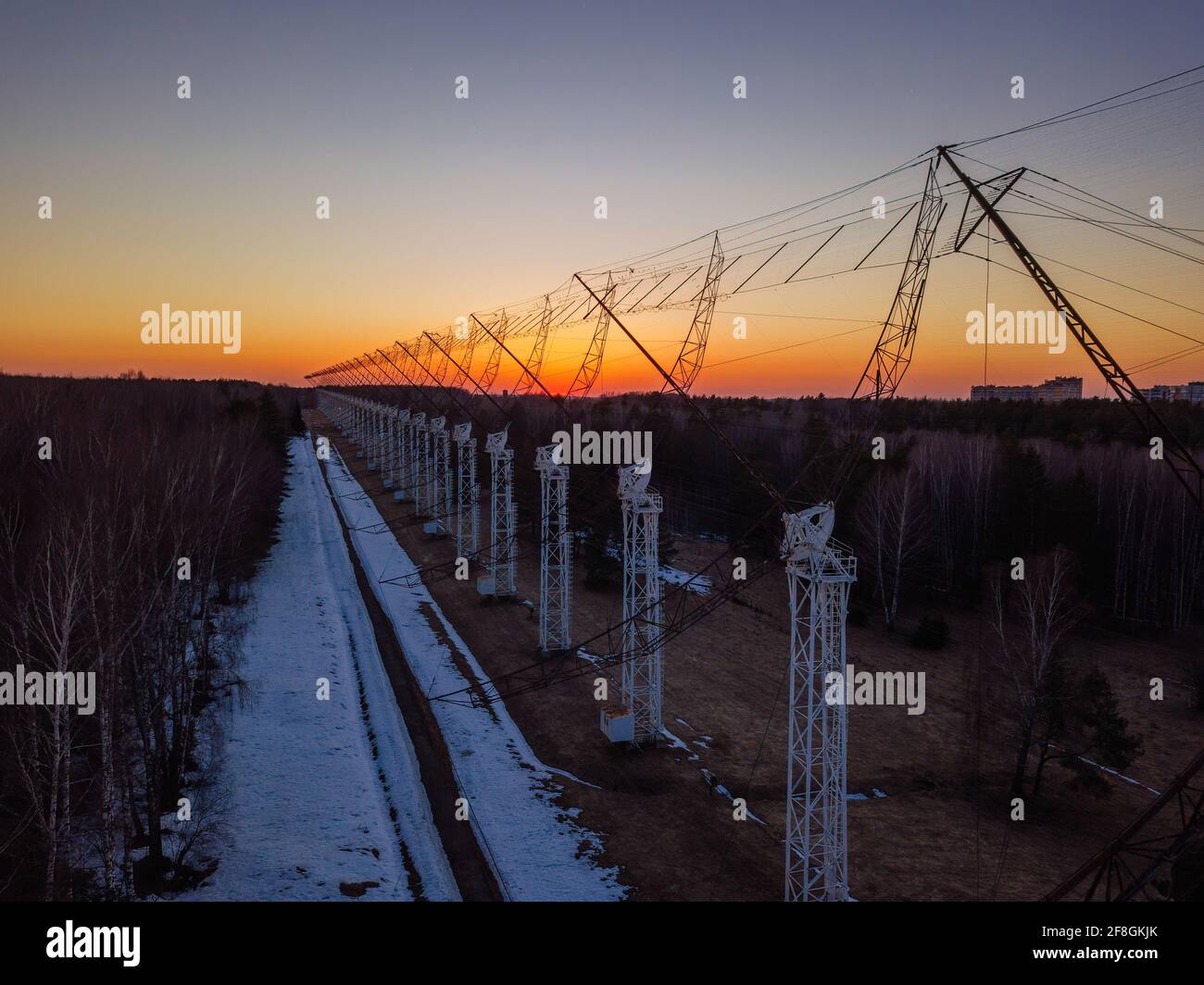 Antenna Array. A long row of radio telescopic antennas at the sunset. Stock Photo