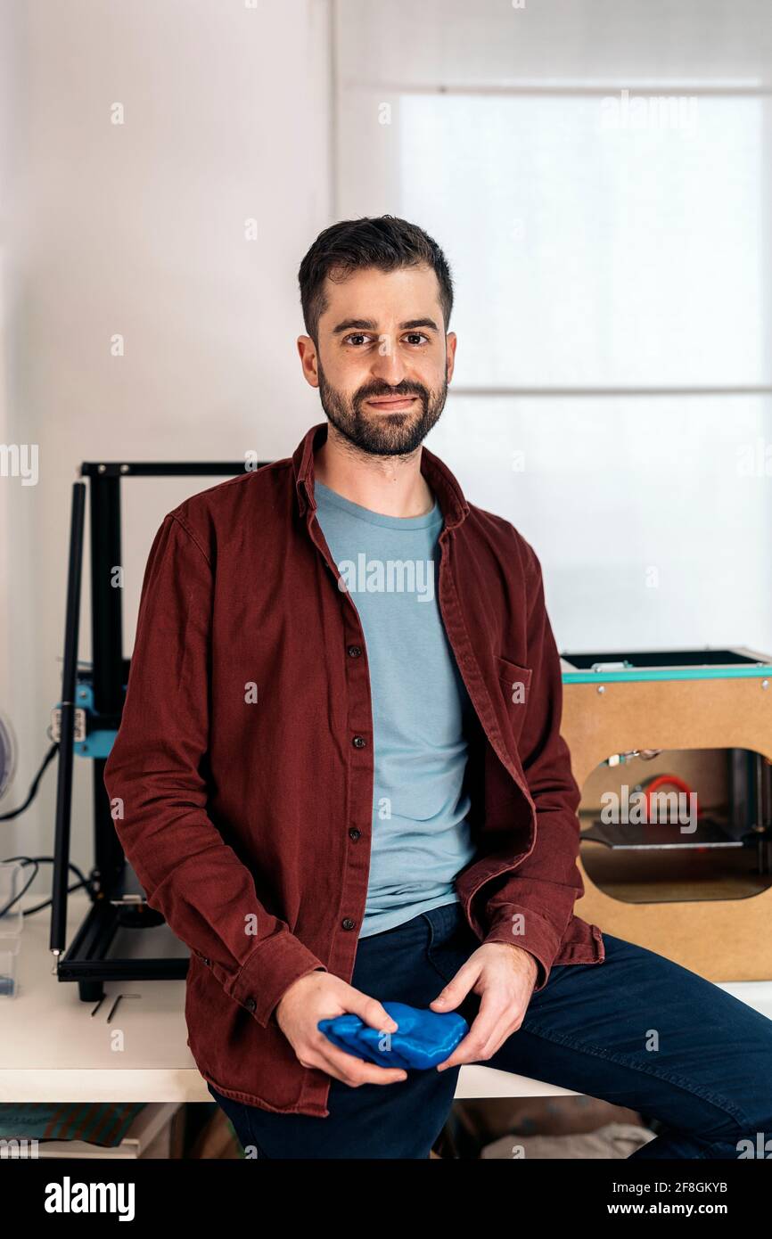 Stock photo of happy young man looking at camera in his 3d printing ...