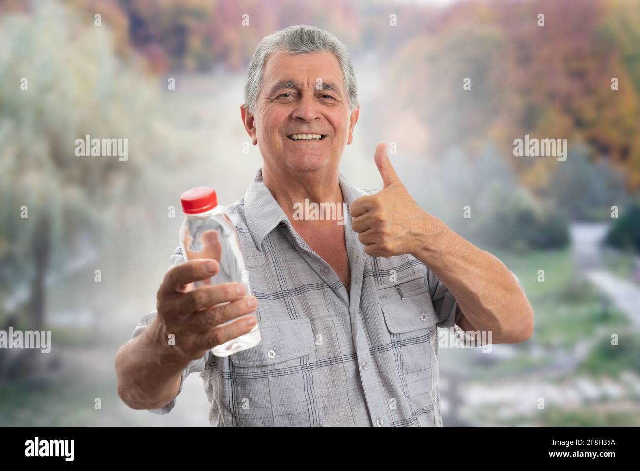 https://c8.alamy.com/comp/2F8H35A/old-man-wearing-casual-summer-shirt-clothing-holding-water-bottle-smiling-making-thumb-up-like-gesture-as-hydration-concept-forest-nature-background-2F8H35A.jpg