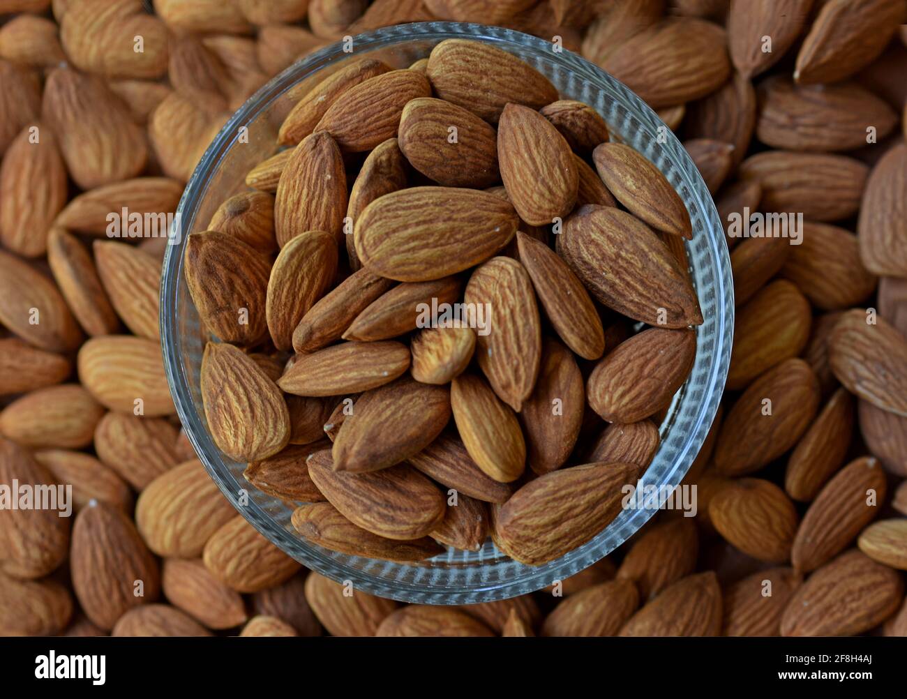 Almonds in bowl, Group of almond nuts isolated on white background Depth of field Stock Photo