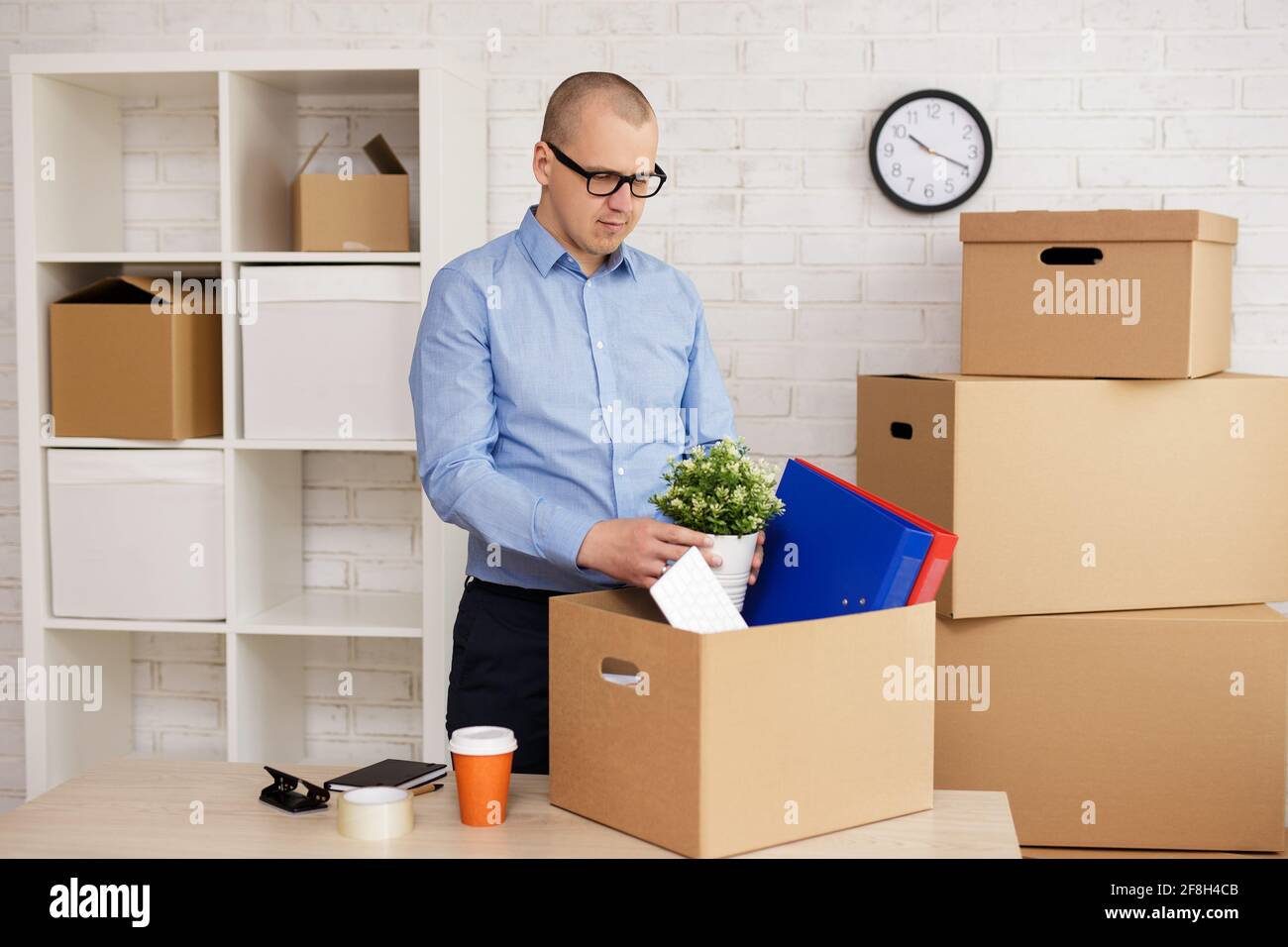 moving day, last day in office - happy businessman packing things in boxes  Stock Photo - Alamy