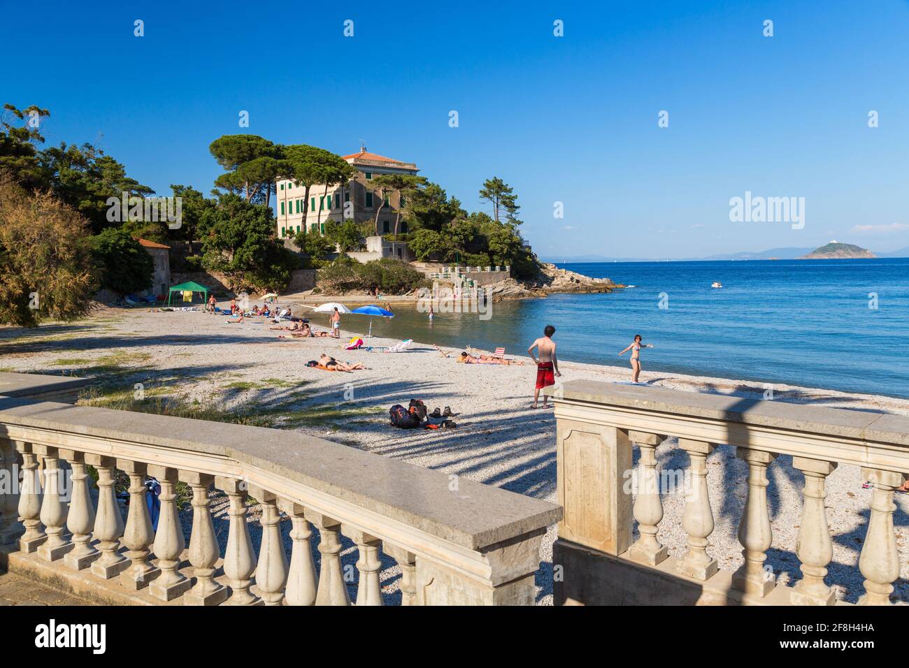 People on the beach and the terrace of a traditional villa, Cavo, Elba