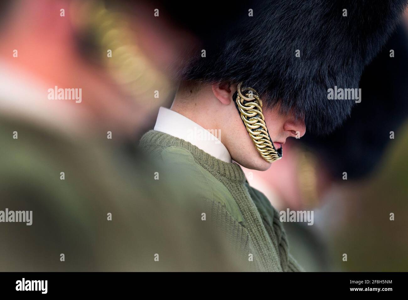 Soldiers from the Coldstream Guards bow their heads as they rehearse for the Duke of Edinburgh's funeral on the Drill Square at the Army Training Centre Pirbright in Woking, Surrey. The Duke's funeral will be held at Windsor Castle on Saturday following his death at the age of 99 on April 9. Picture date: Wednesday April 14, 2021. Stock Photo