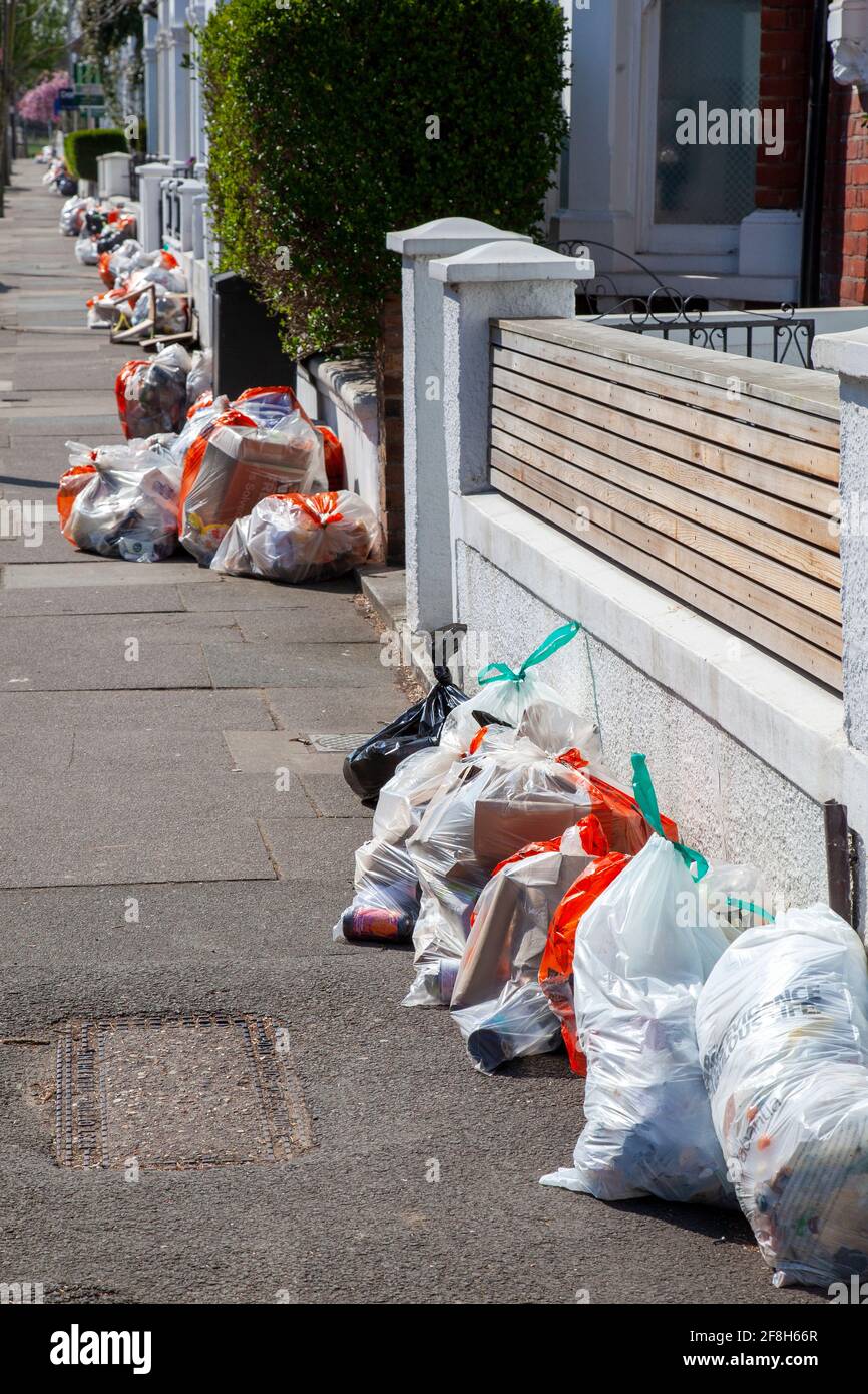 Rubbish Bags on Pavement for Collection in Wandsworth - London UK Stock Photo