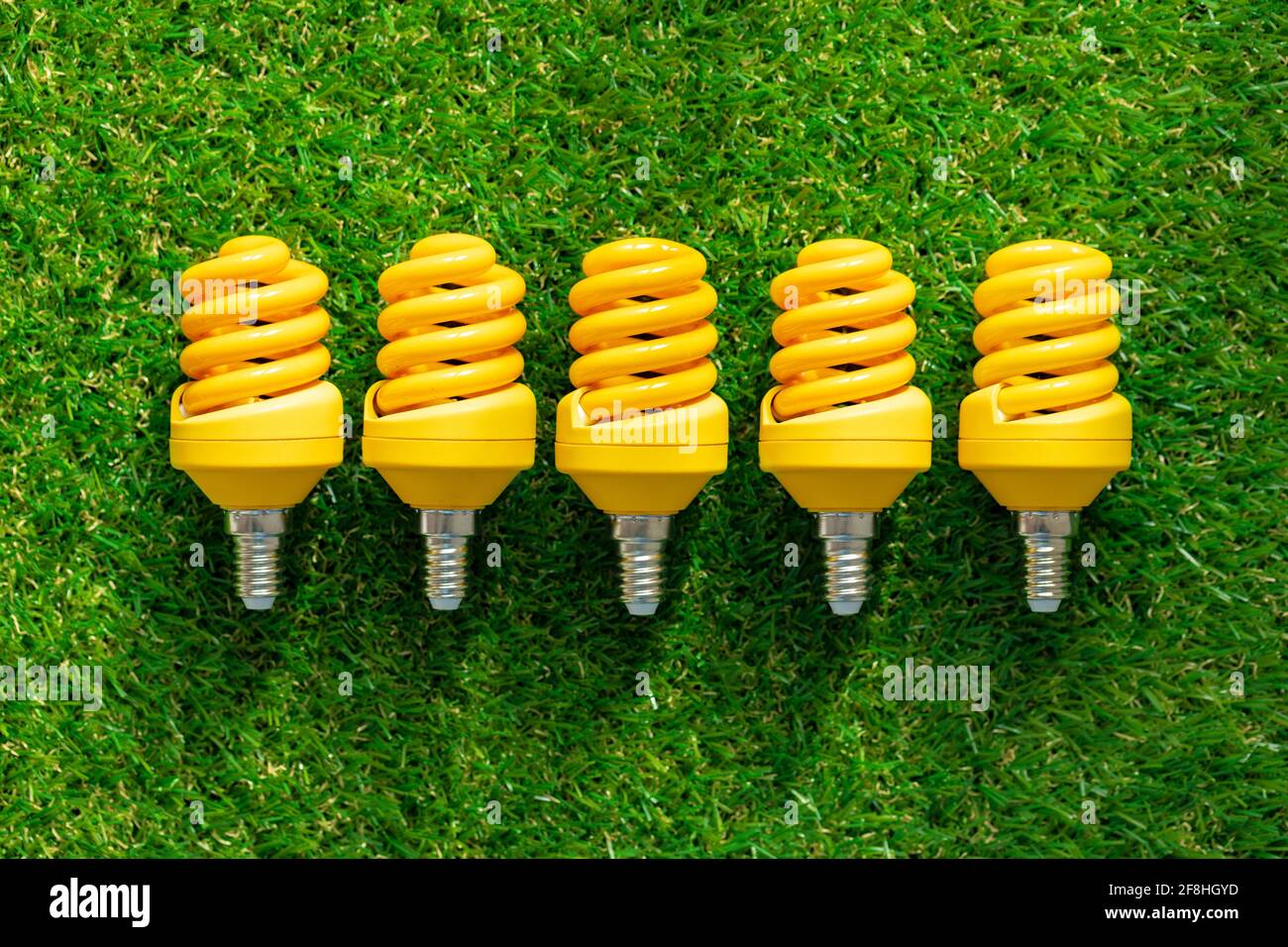 Energy efficient light bulb lying on grass Stock Photo - Alamy