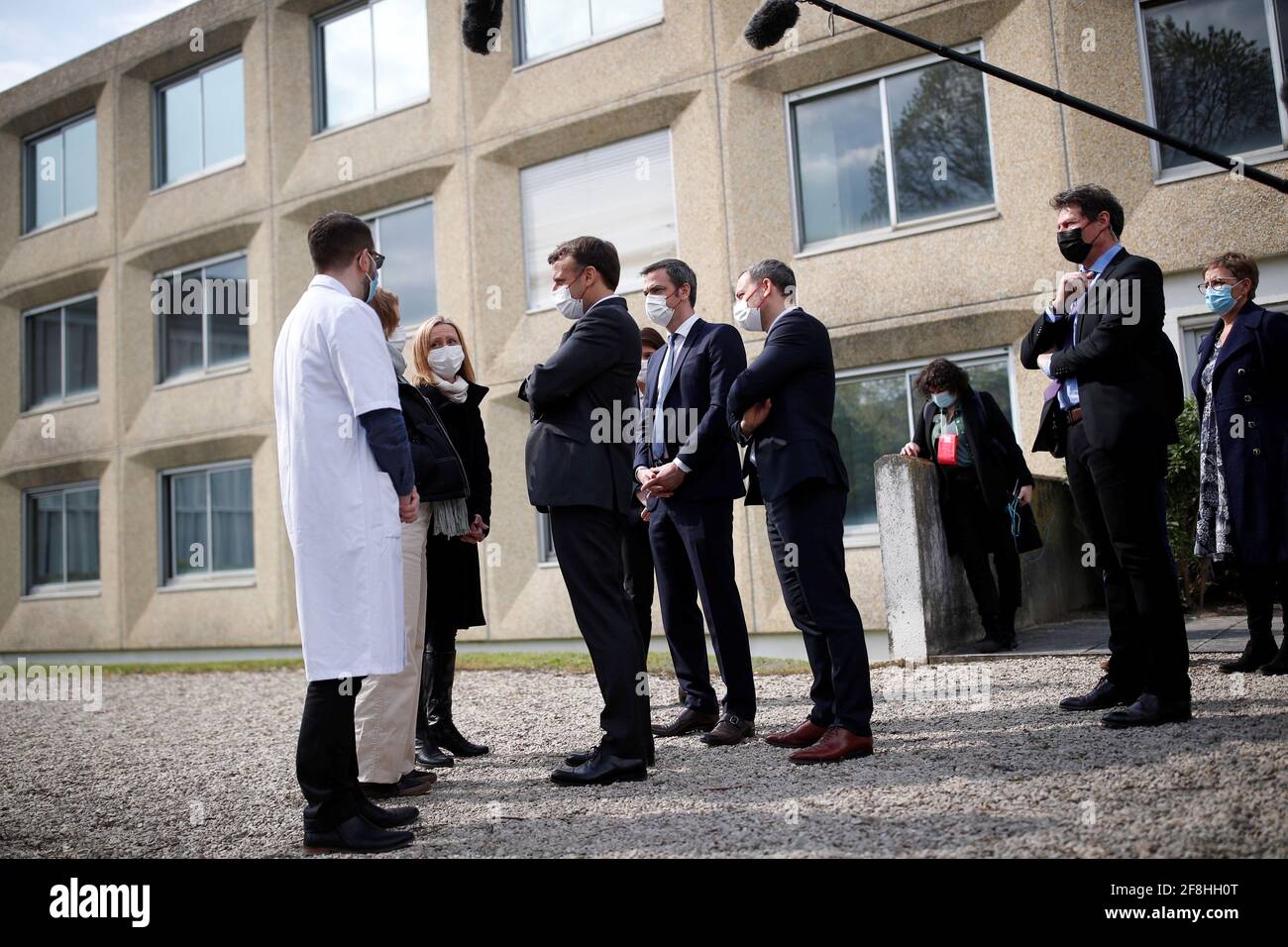 French President Emmanuel Macron talks with medical staff as he visits a child psychiatry department at Reims hospital to discuss the psychological impact of the COVID-19 crisis and the lockdown on children and teenagers in France, April 14, 2021.  REUTERS/Christian Hartmann/Pool Stock Photo
