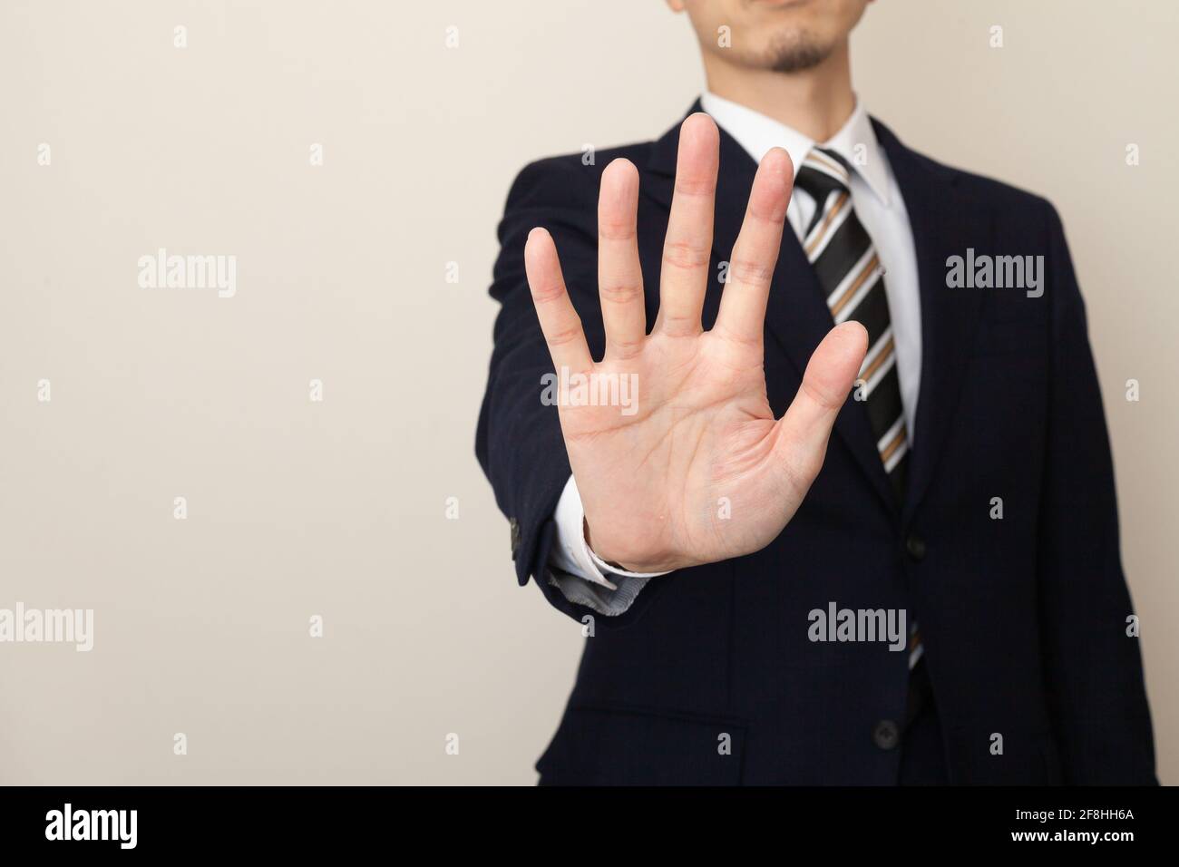 Man in a suit giving a ban, stop hand sign Stock Photo