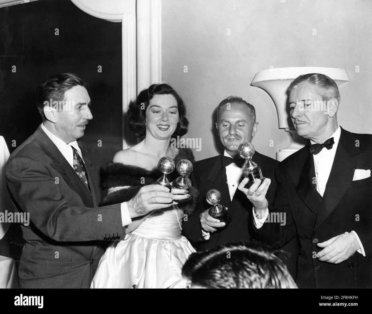 1948 5th Golden Globes Awards of the Hollywood Press Association on March 10th with winners of awards for Best Films of  1947 from left WALT DISNEY (Special Achievement Award) ROSALIND RUSSELL (Best Actress for Mourning Becomes Electra) DARRYL F. ZANUCK (Best Film Gentleman's Agreement) and RONALD COLMAN (Best Actor for A DOUBLE LIFE) held at the Hollywood Roosevelt Hotel in Los Angeles Stock Photo