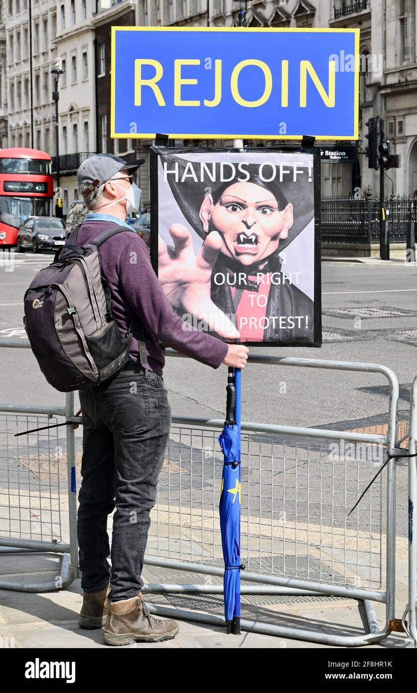 London. UK. 14th April 2021, A man demonstrates in Parliament Square in support of the right to protest. He holds a placard with a caricature of Home Secretary Priti Patel, Westminster, London. Stock Photo
