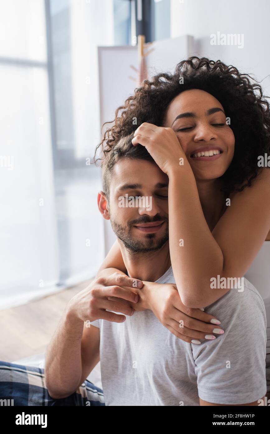 happy african american woman hugging bearded boyfriend Stock Photo - Alamy