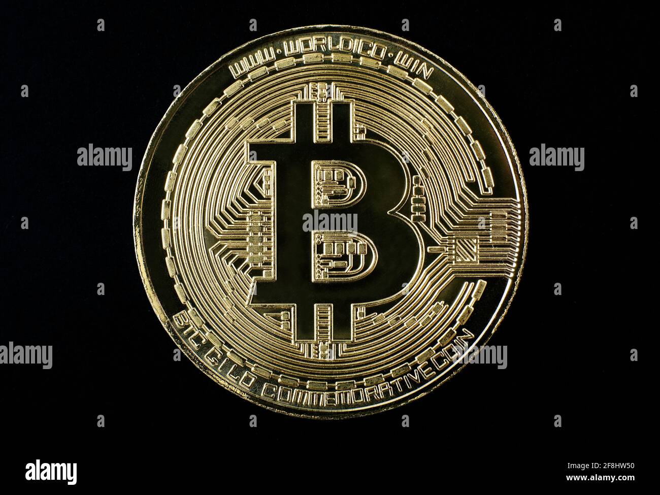 gold plated bitcoin coin on black background Stock Photo - Alamy