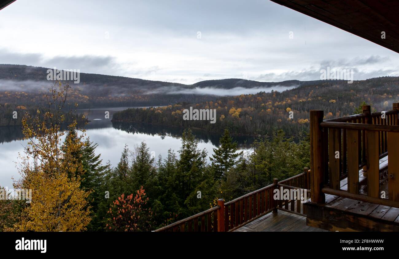 view of a lake down the hill from a balcony in an hotel and low clouds Stock Photo