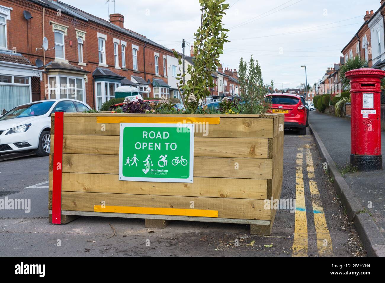 Some roads in Kings Heath, Birmingham have become closed to traffic and cars with wooden planters blocking access to cars Stock Photo
