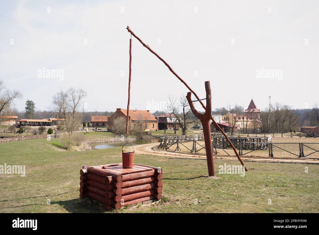 the bucket is fixed on a special adaptation of the crane and hangs over the well Stock Photo