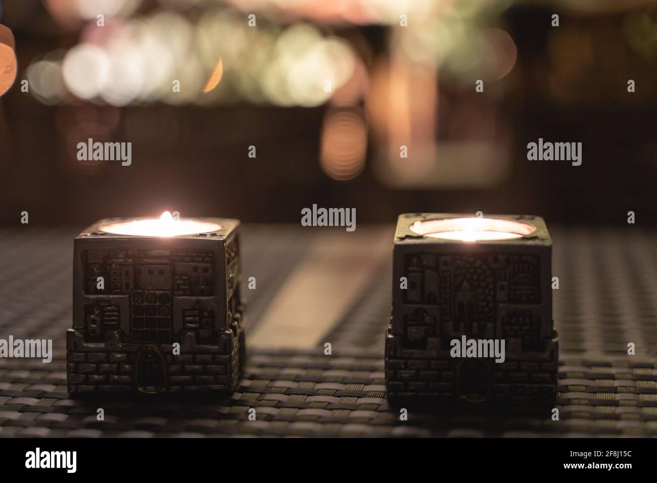 Silver candles lights on Friday night dinner for popular Shabbat meal