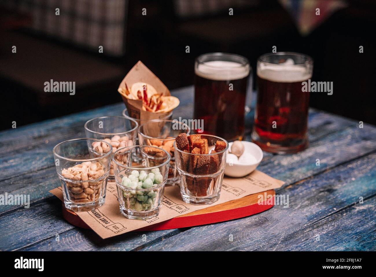 snacks to beer in glass glasses on a wooden table. Stock Photo