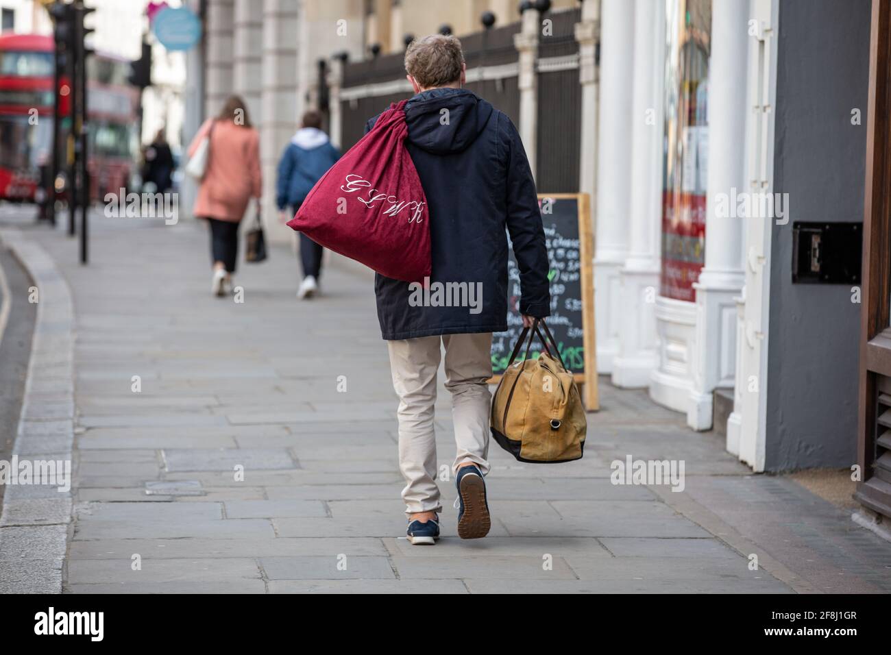 A Barrister carries his work belongings along the street in Law district of the Temple area of central London, England, United Kingdom Stock Photo