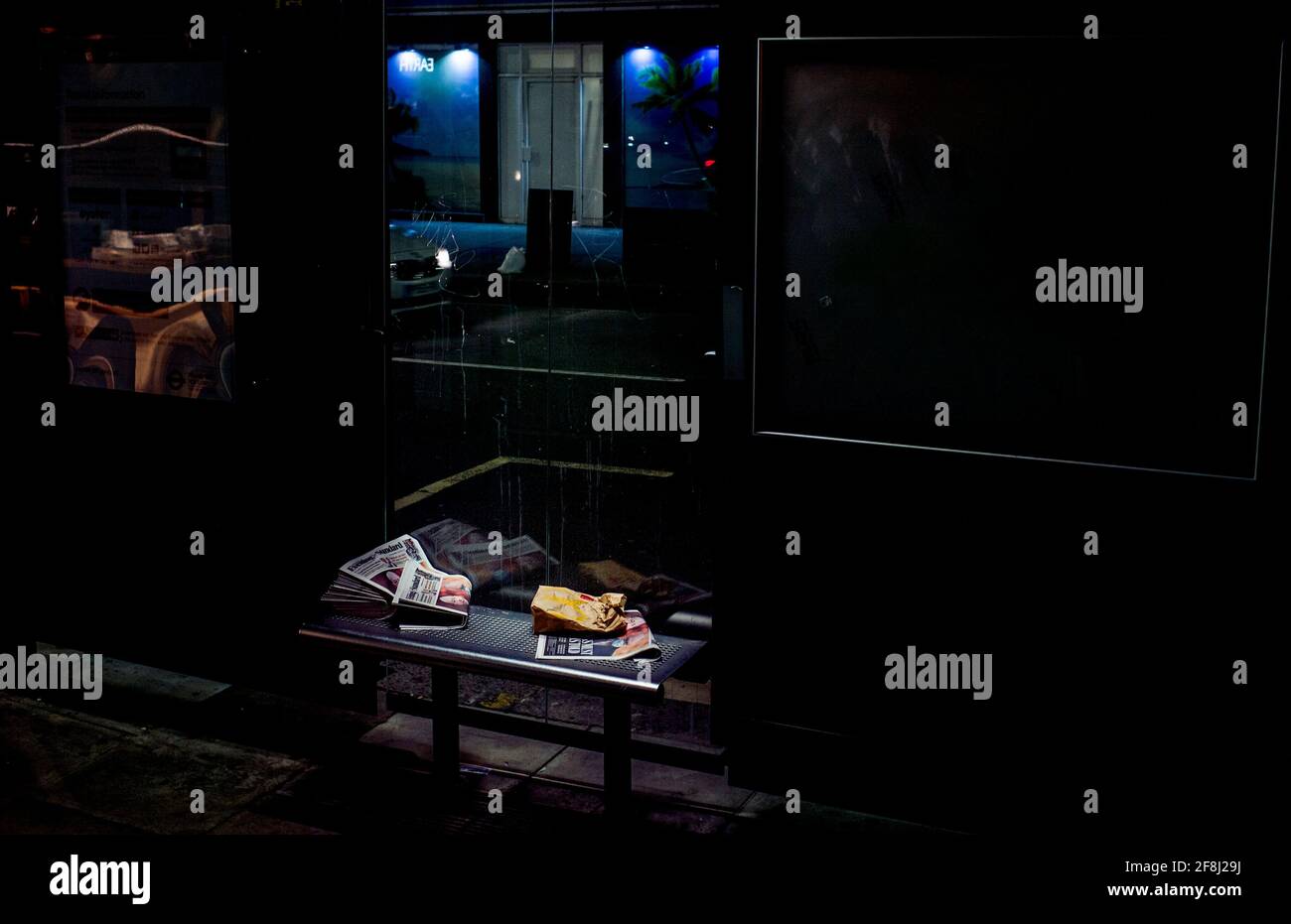 newspapers left at a bus stop, litter on bench Stock Photo Alamy