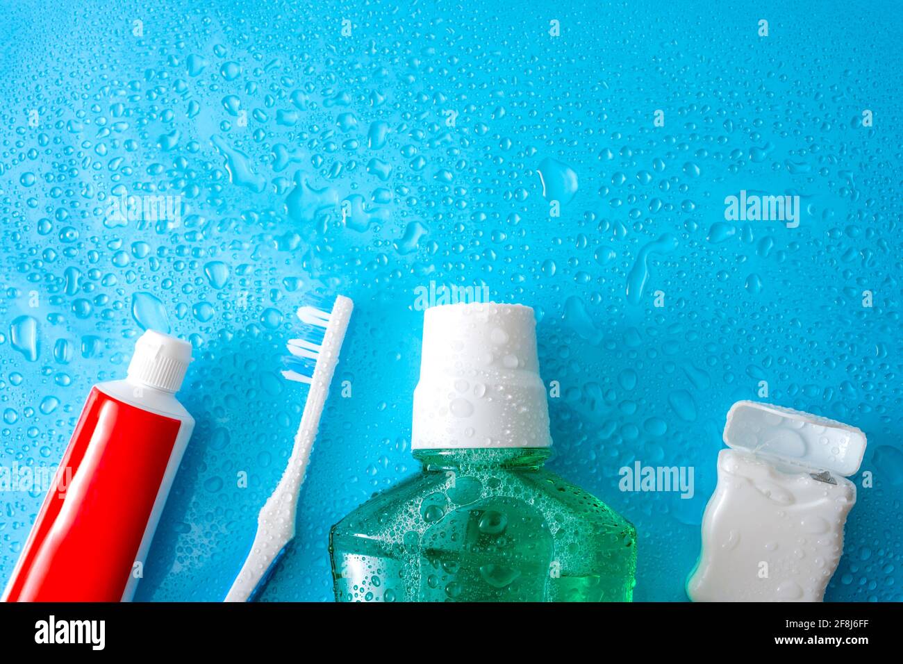 Toothpaste Water Dental care and oral hygiene concept with a bottle of green mouthwash ...