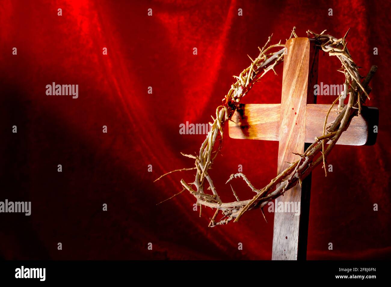 Christianity, Resurrection of Jesus Christ and Christian holiday of Easter concept with a bright beam of light shining on a cross and a crown of thorn Stock Photo