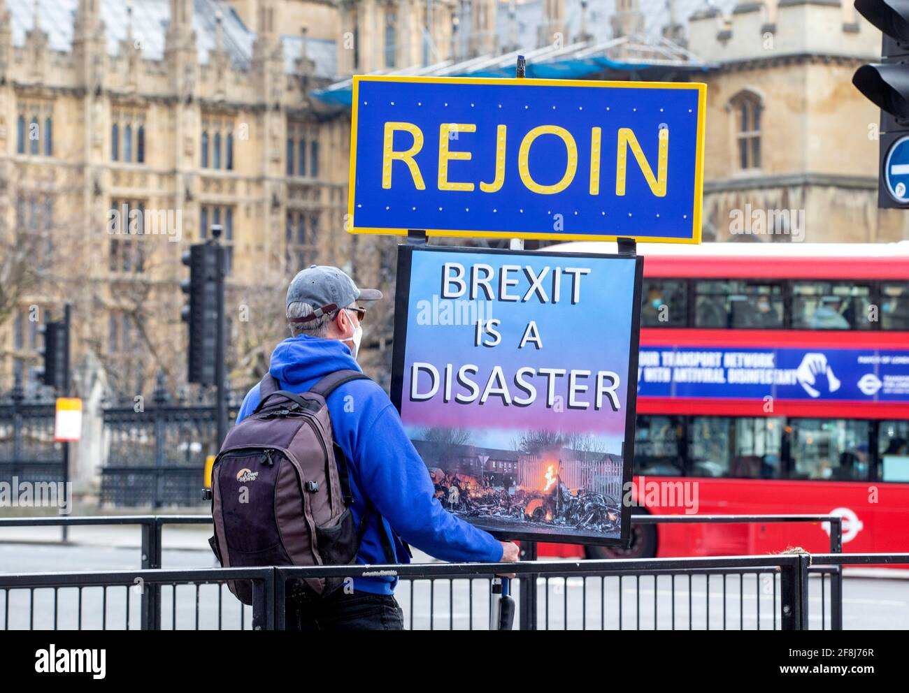 A protestor in Westminster with a 'Rejoin' sign. He wants to rejoin the European Union and sees Brexit as a disaster for the United Kingdom. Stock Photo