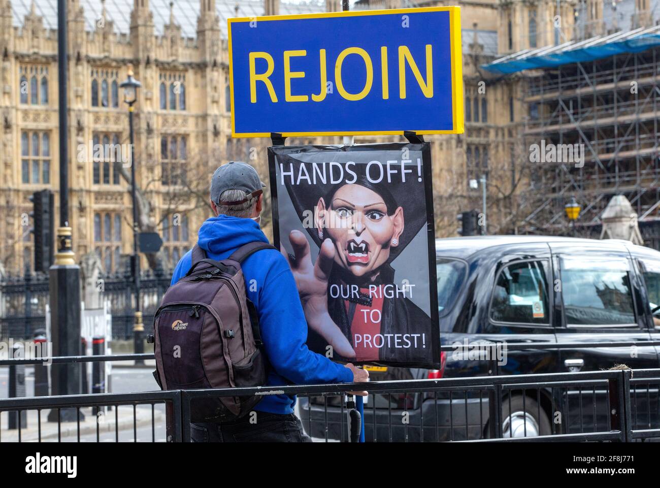 A protestor in Westminster with a 'Rejoin' sign. He wants to rejoin the European Union and sees Brexit as a disaster for the United Kingdom. Stock Photo