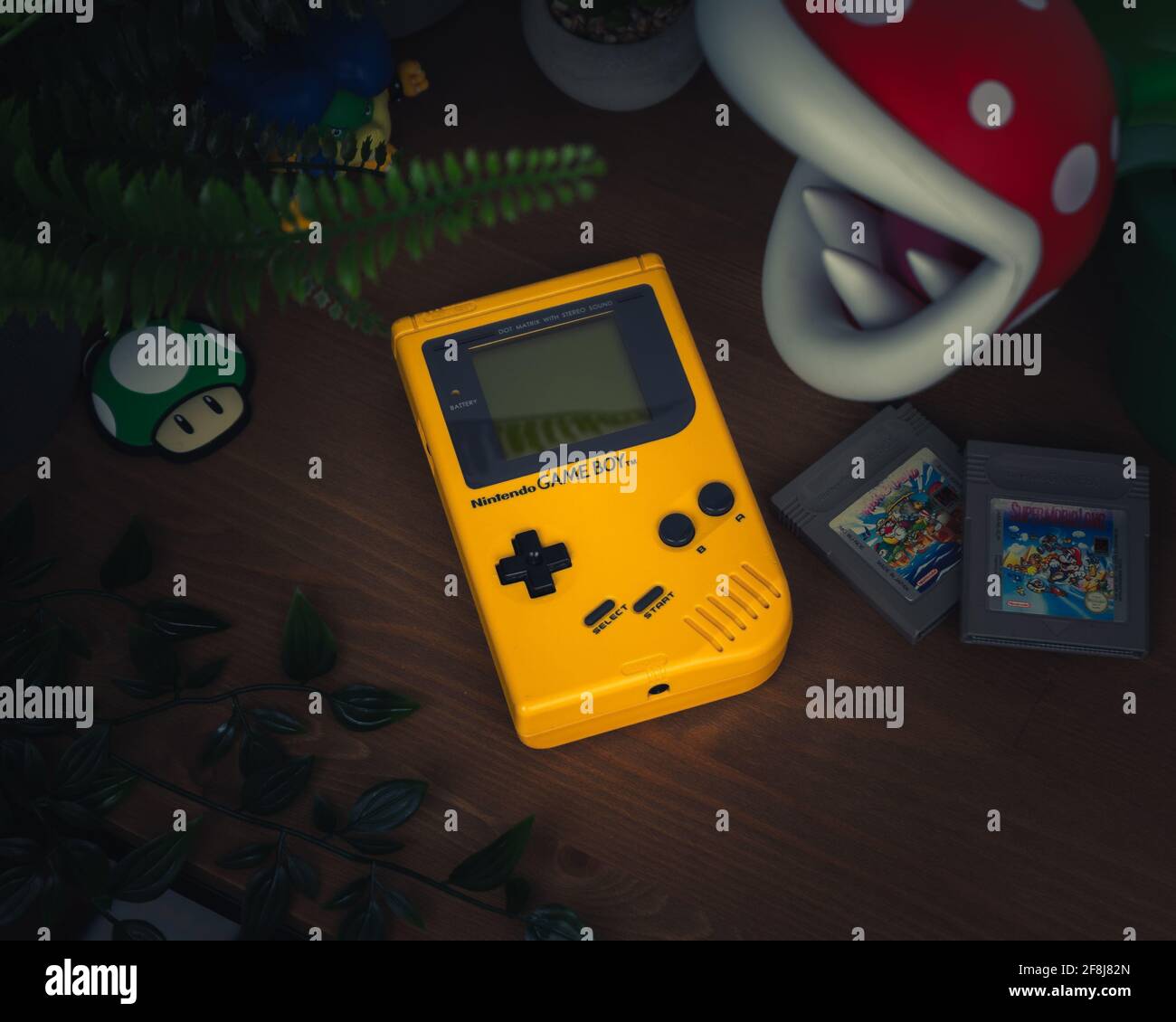 HAMBURG, GERMANY - Mar 16, 2021: The Original Gameboy DMG-01 in Yellow, together with Super Mario Land 2 Stock Photo