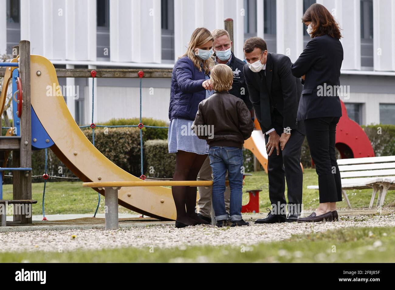French President Emmanuel Macron talks to a child as he visits a child psychiatry department at Reims hospital to discuss the psychological impact of the COVID-19 crisis and the lockdown on children and teenagers in France, April 14, 2021. Photo by Christian Hartmann/Pool/ABACAPRESS.COM Stock Photo