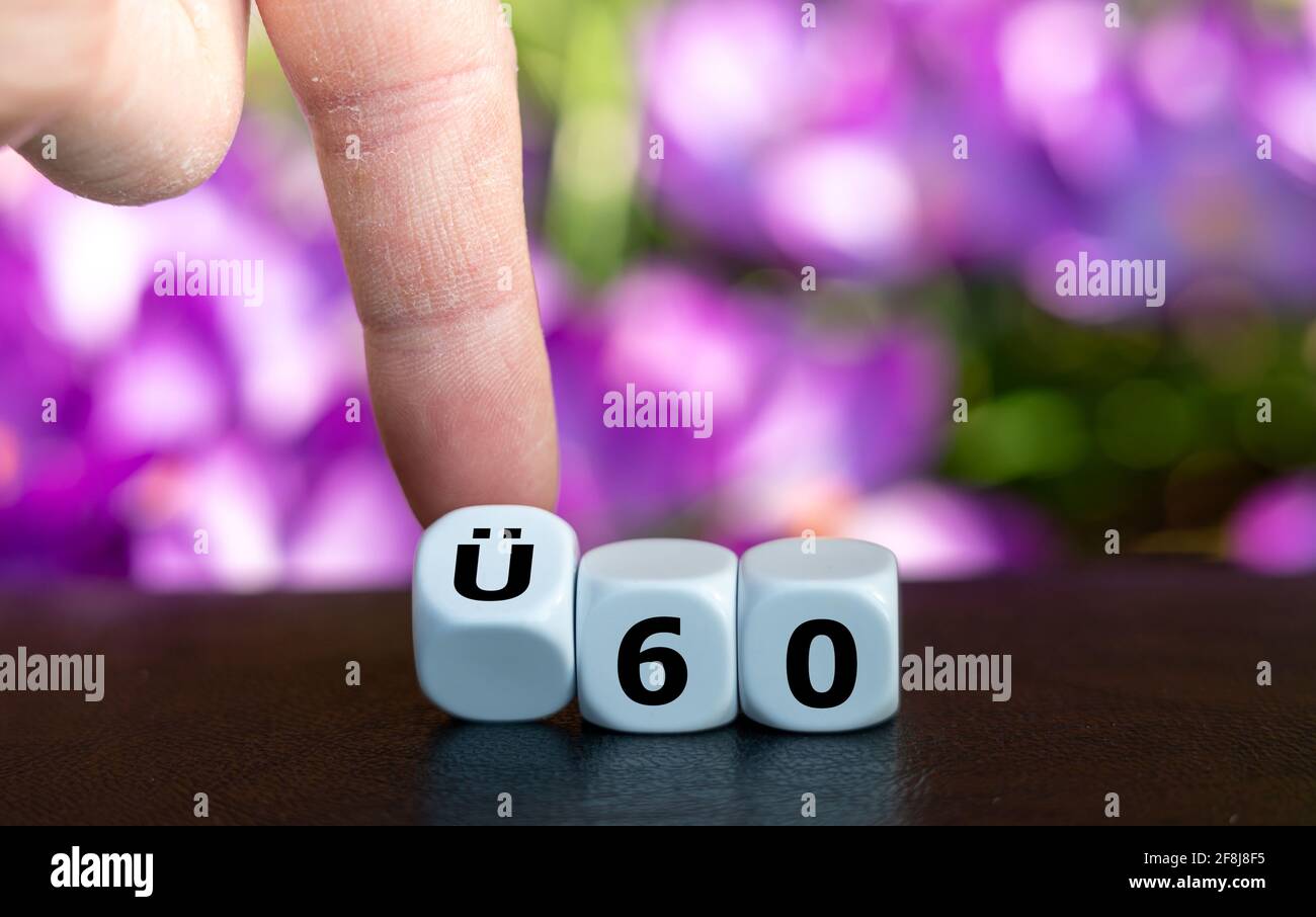 Dice form the German expression 'UE 60' (above 60 years old) as symbol for people older than 60 years. Stock Photo