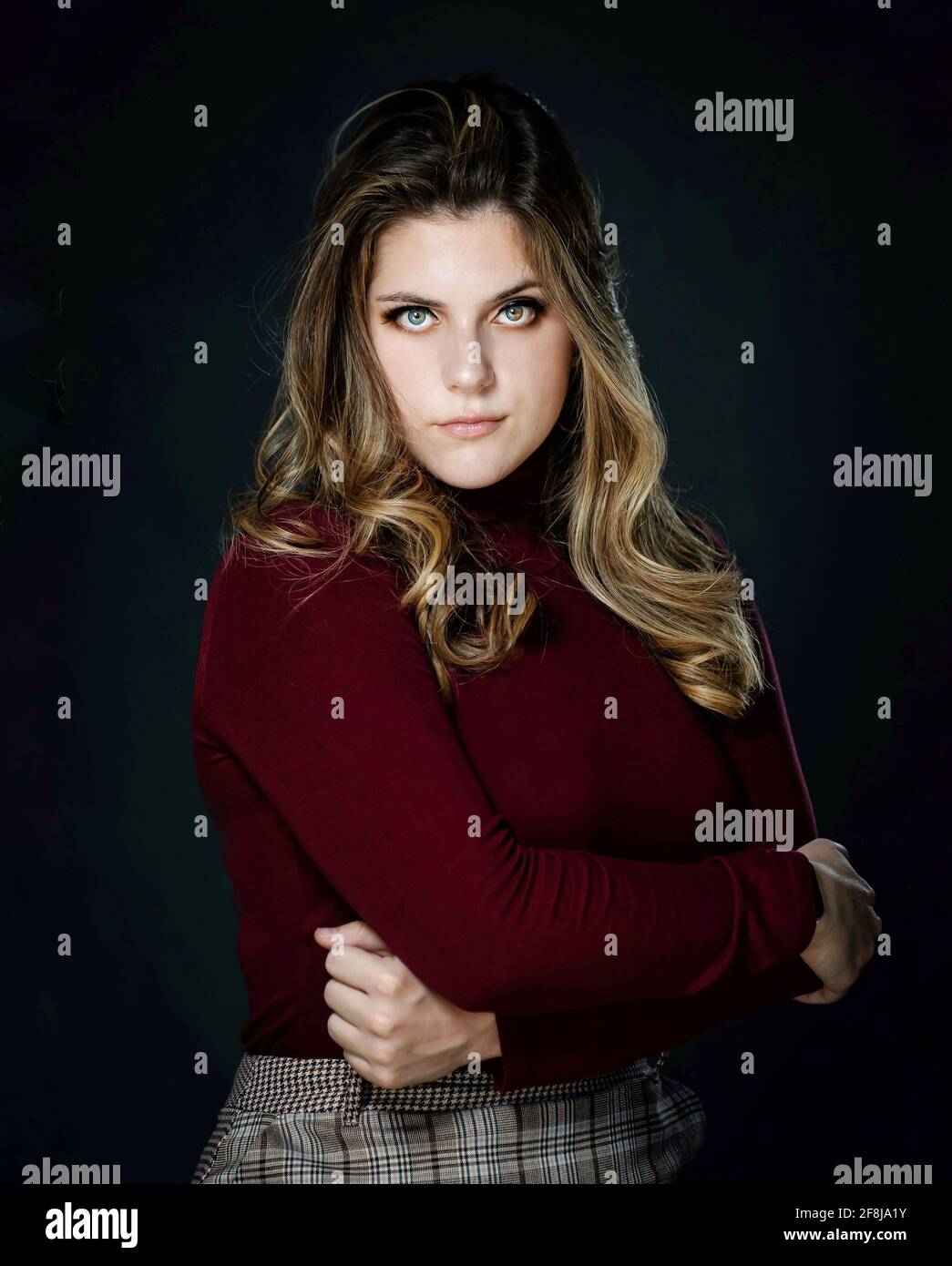 Portrait of a serious young woman standing with her arms crossed Stock ...