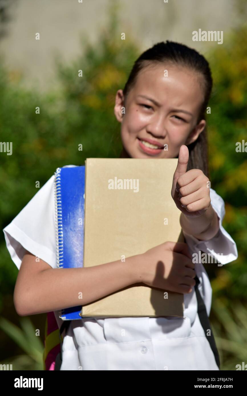 Girl Student With Thumbs Up With Books Stock Photo - Alamy