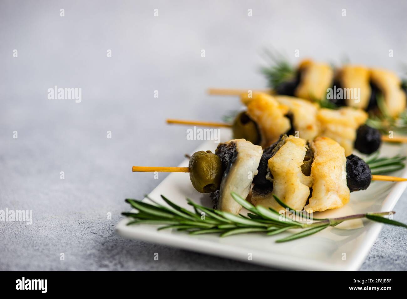 Barbecue fish skewers with olives and rosemary Stock Photo Alamy