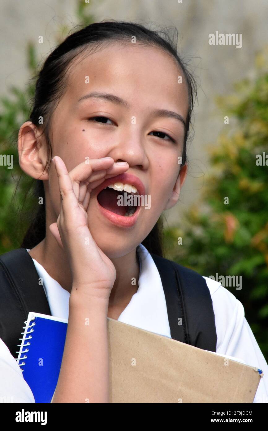 Youthful Asian Girl Student Shouting With Books Stock Photo - Alamy