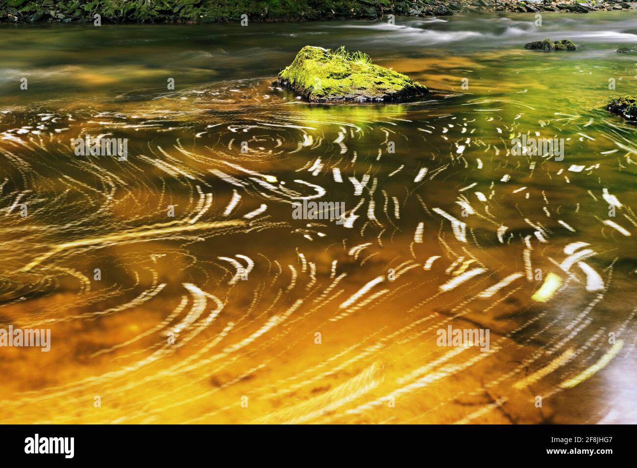 Vivid color game lines on water level of small mountain river. Stock Photo