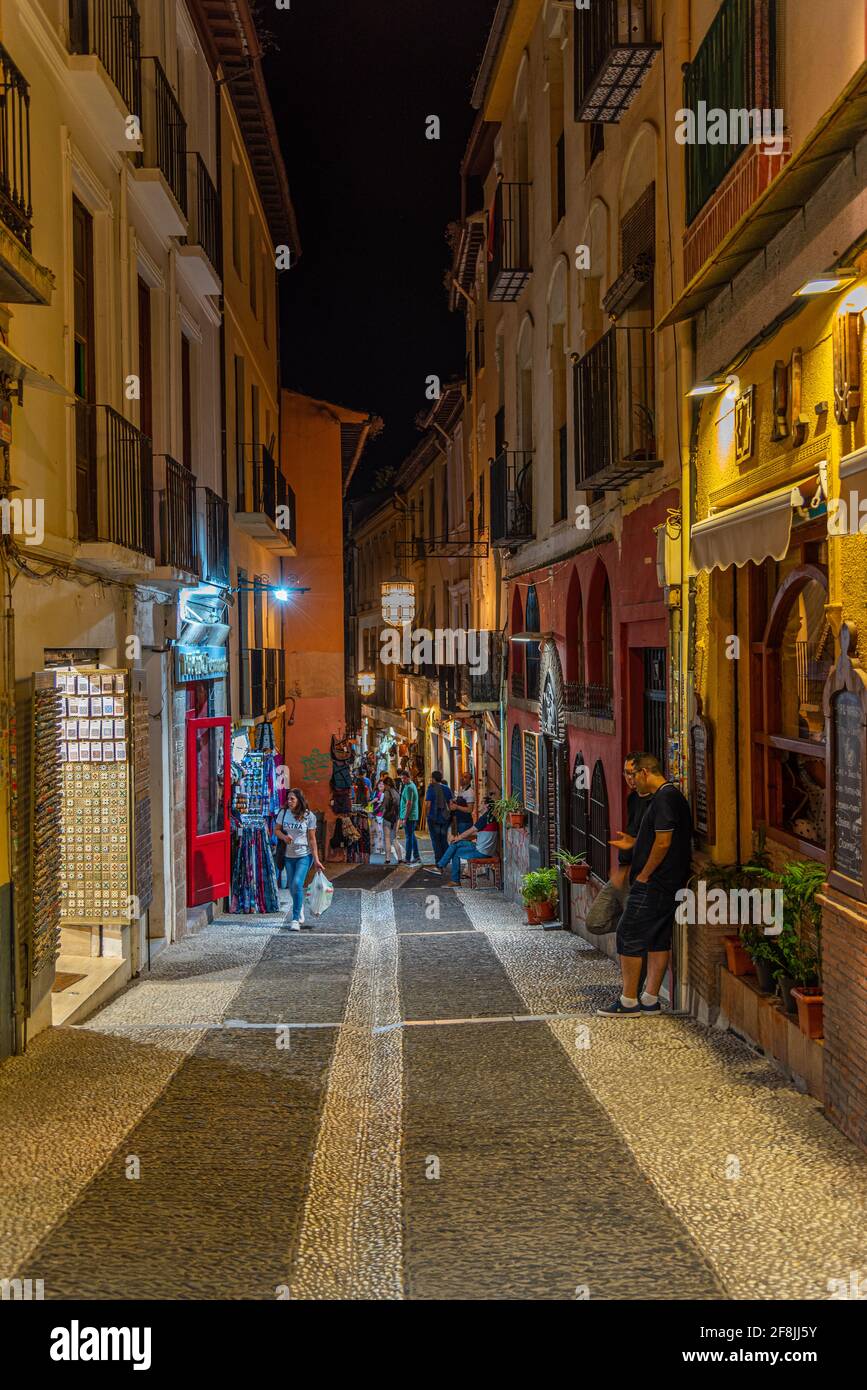 GRANADA, SPAIN, JUNE 21, 2019: Nightlife in a narrow street in Albaicin district of Granada, Spain Stock Photo