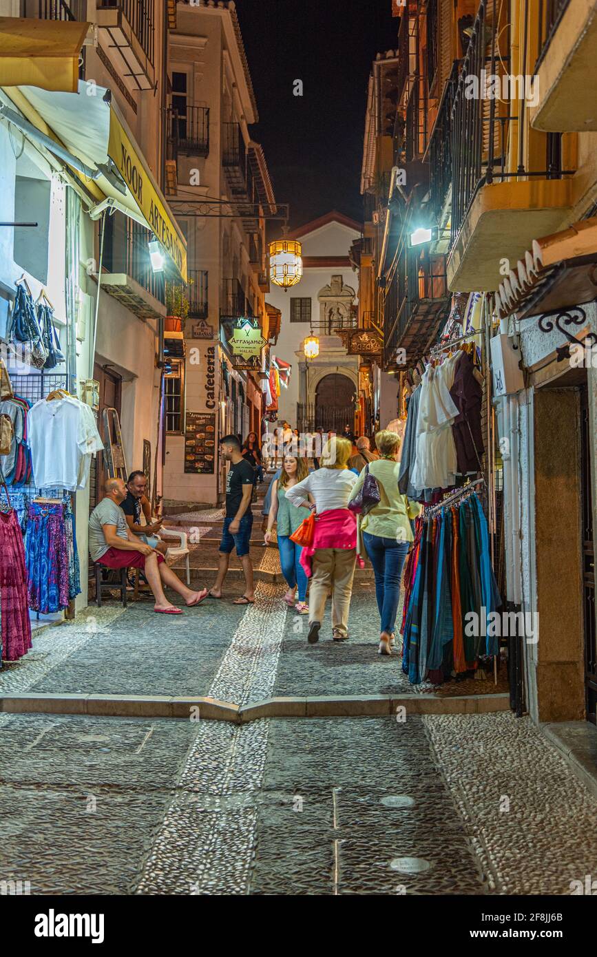 GRANADA, SPAIN, JUNE 21, 2019: Nightlife in a narrow street in Albaicin district of Granada, Spain Stock Photo