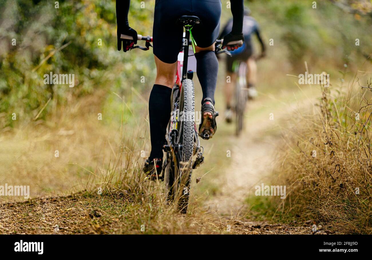 rear wheel mountain bike riding on trail with dry grass Stock Photo - Alamy